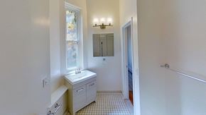 Jersey Ave apartment for rent - A white bathroom with a sink, mirror, and bathtub.