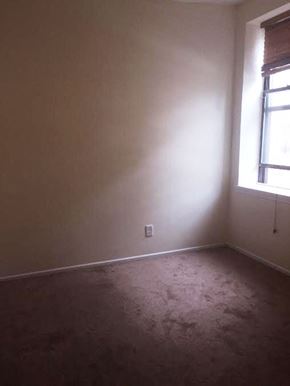 Jersey City apartment for rent - A room with a window and a carpeted floor.