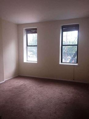 Jersey City apartment for rent - A room with two windows and carpeted floor.