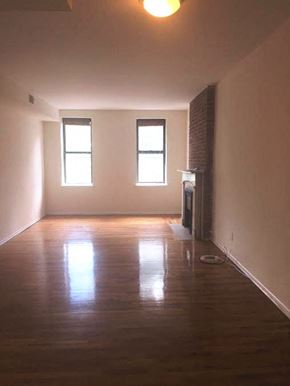 Jersey City apartment for rent - A room with wooden floors and two windows.