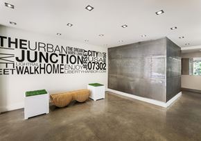 Jersey City apartment for rent - a lobby with a bench and a wall with words on it