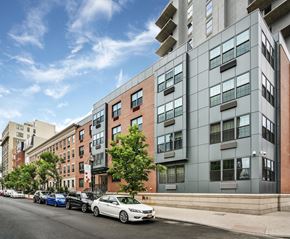 Jersey City apartment for rent - an apartment building on a city street with parked cars
