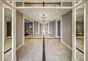 Jersey City apartment for rent - a long hallway with white doors and tiled floors and