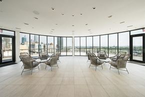 Jersey City apartment for rent - a meeting room with views of the city and a table and chairs