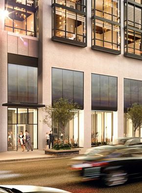 Chicago apartment for rent - a car driving down a street in front of a building