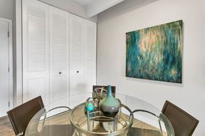 Denver apartment for rent - a dining room with a glass table and a painting on the wall
