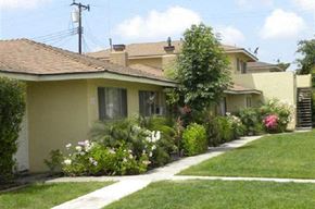 Garden Grove apartment for rent - a row of houses with a garden in front of them