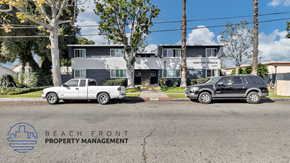 El Monte apartment for rent - a view of the beach front property management building with two cars parked in front