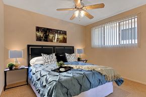 Sherman Oaks apartment for rent - A bedroom with a bed, nightstands, and a ceiling fan.