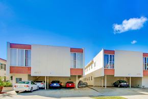 Los Angeles apartment for rent - A modern building with cars parked in front.