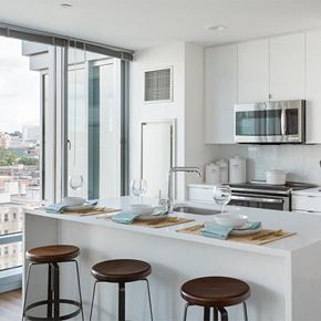 Boston apartment for rent - a kitchen with a counter top and some stools
