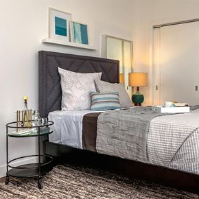 Boston apartment for rent - a bedroom with a bed and pillows and a table