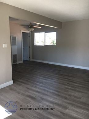 Anaheim apartment for rent - an empty living room with wood floors and a ceiling fan