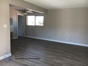 Anaheim apartment for rent - an empty living room with wood floors and a ceiling fan