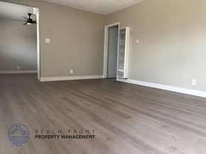 Anaheim apartment for rent - A room with wooden flooring and a closed door is shown.