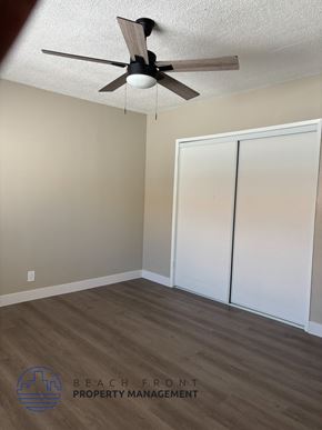 Anaheim apartment for rent - A room with a ceiling fan and a sliding door.