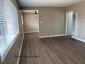 Anaheim apartment for rent - A room with wooden flooring and a ceiling fan.