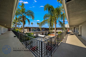 Santa Ana apartment for rent - a balcony with palm trees and a patio with a pool