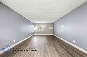 Santa Ana apartment for rent - a spacious living room with hardwood flooring and a window