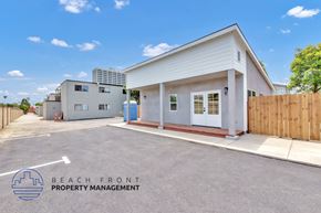 Costa Mesa apartment for rent - A white building with a sign that says Beach Front Property Management.