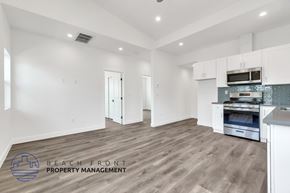 Costa Mesa apartment for rent - A spacious kitchen with white cabinets and a stainless steel oven.