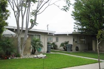 Buena Park apartment for rent - a house with a lawn and trees in front of it