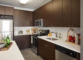 North Bergen apartment for rent - a kitchen with stainless steel appliances and wooden cabinets