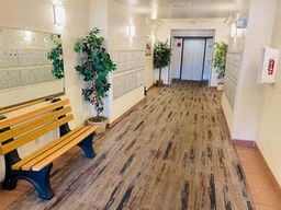 Everett apartment for rent - a hallway with benches and plants in a building