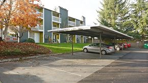 Lynnwood apartment for rent - a parking lot with cars in front of an apartment building