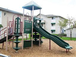 Marysville apartment for rent - a playground with a slide in front of a building