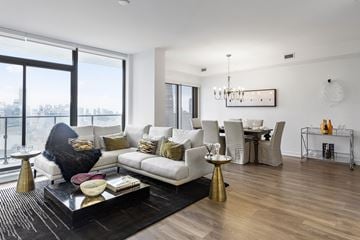 Toronto apartment for rent - A modern living room with a white sofa and a black coffee table.