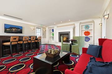 West Jordan townhouse for rent - a living room with red and blue furniture and a fireplace