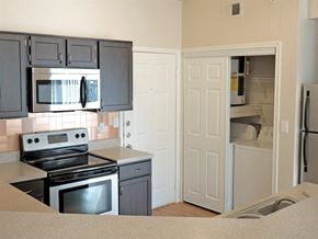 Irving townhouse for rent - A kitchen with black cabinets and a stove top oven.