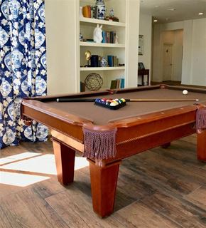 Irving townhouse for rent - A pool table with a brown cloth and a set of balls on it.