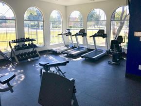 Irving townhouse for rent - A gym with treadmills, exercise bikes, and dumbbells.