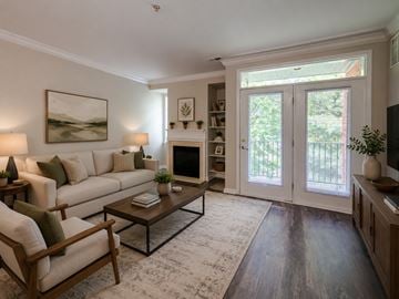 Cherry Hill apartment for rent - A living room with a white couch, a coffee table, and a painting on the wall.
