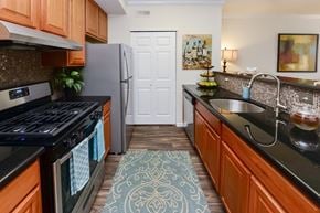 Cherry Hill apartment for rent - a kitchen with stainless steel appliances and wooden cabinets