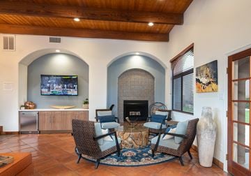 Tempe apartment for rent - a living room with a table and chairs and a fireplace