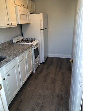 Quincy apartment for rent - Kitchen with granite counters and white cabinets