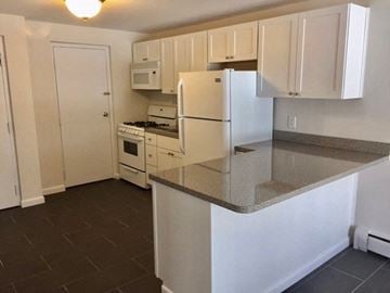 Quincy apartment for rent - a kitchen with a counter top and a refrigerator