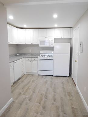 Quincy apartment for rent - Renovated kitchen with granite counters, white cabinets and white appliances