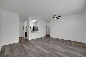 Eugene apartment for rent - A spacious room with a ceiling fan and wooden flooring.