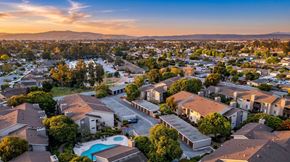 Salinas apartment for rent - A sunset view of a residential area with houses and a swimming pool.