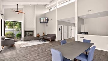 Salinas apartment for rent - A modern living room with a grey table and blue chairs.