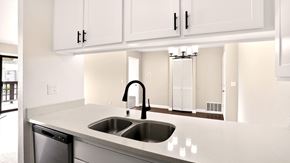 Salinas apartment for rent - A modern kitchen with a stainless steel sink and white cabinets.