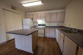 Flagstaff apartment for rent - a kitchen with white appliances and counters and a sink