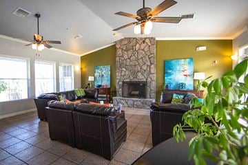 Flagstaff apartment for rent - a living room with leather furniture and a stone fireplace