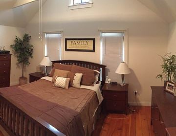 Middleton apartment for rent - a bedroom with a bed and two windows with blinds