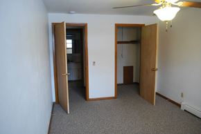 Sun Prairie apartment for rent - an empty room with two doors and a ceiling fan