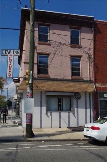Philadelphia apartment for rent - a pink and white building on the corner of a street